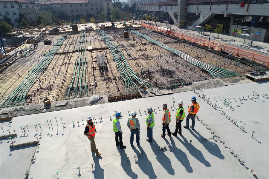 Crews working on a poured slab at a construction site