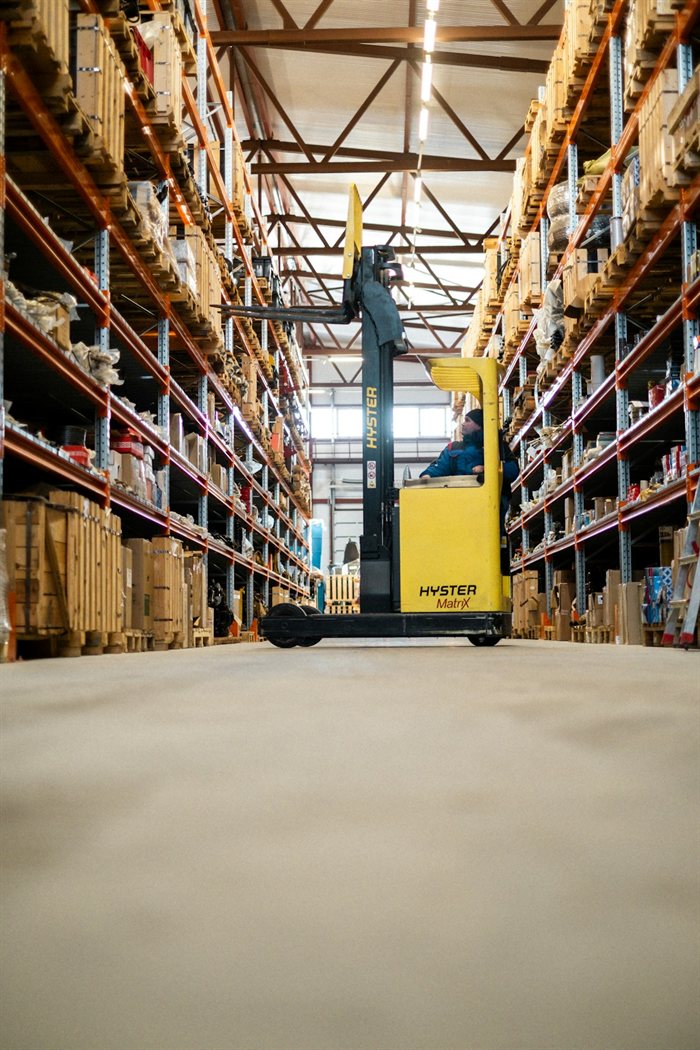 Forklift moving stock inside a distribution warehouse