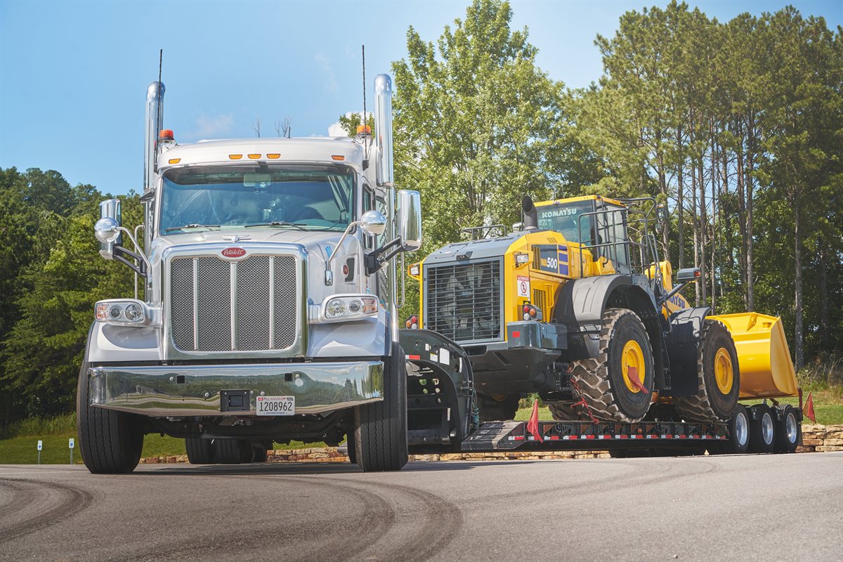 Heavy haul truck carrying an oversized wheel loader